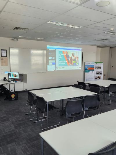 Empty classroom with projector and chairs.
