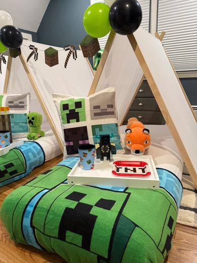 Minecraft-themed indoor tent setup with pillows, plush toys, and decorations.