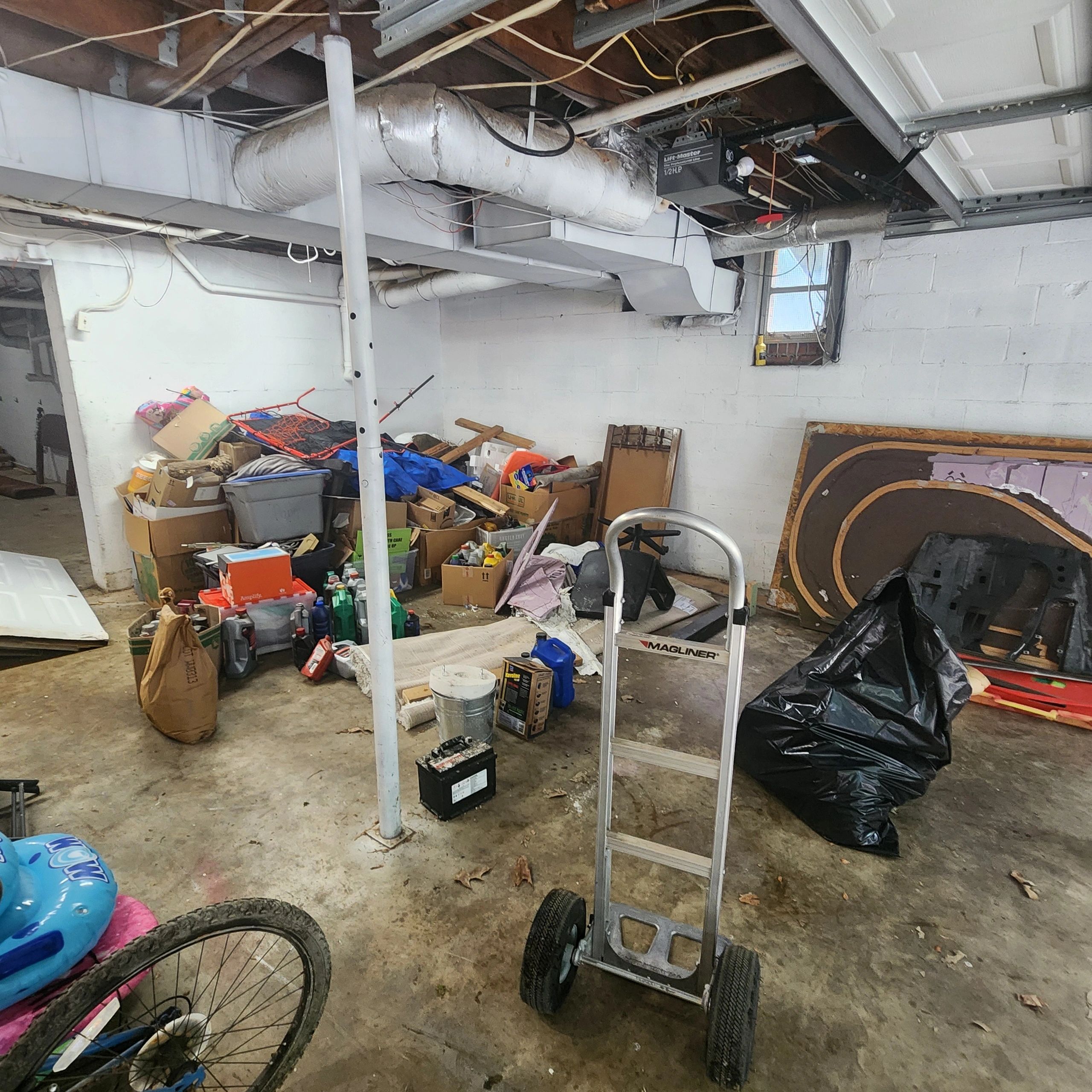 Cluttered basement with tools and supplies.