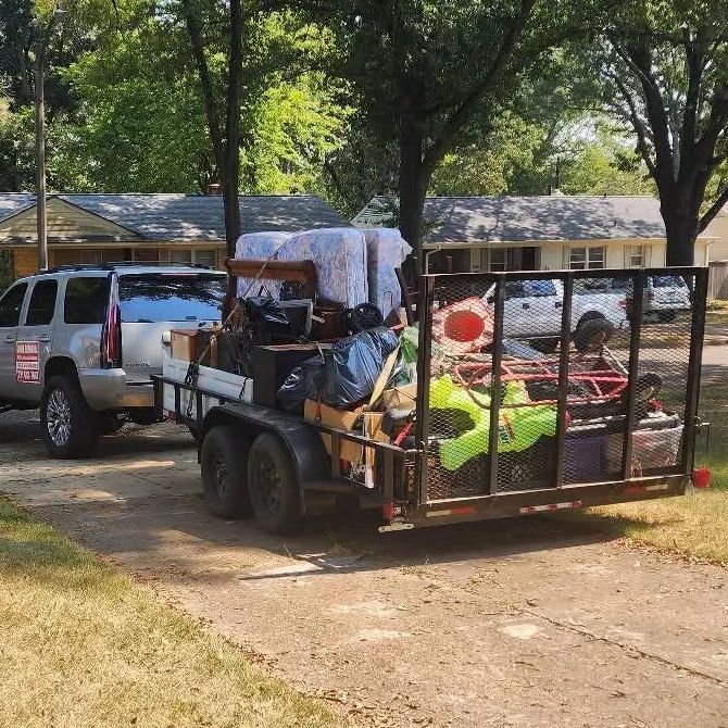 SUV towing a packed trailer with furniture and belongings.