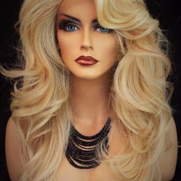 Blonde mannequin head with voluminous hair and bold makeup.