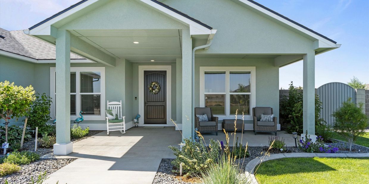 Modern porch with comfortable seating and decorative plants.