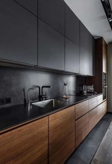 Modern kitchen with dark upper cabinets and wooden lower cabinets.