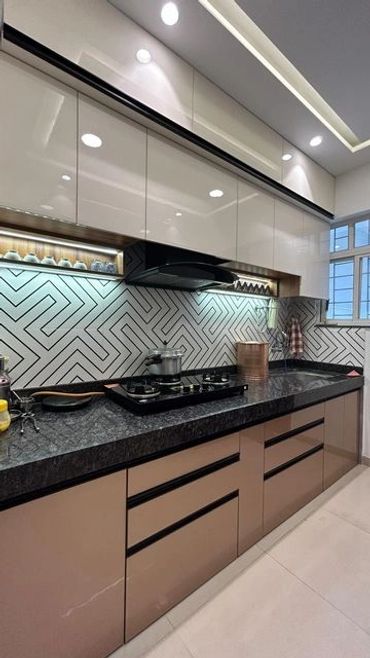 Modern kitchen with sleek cabinetry and patterned backsplash.