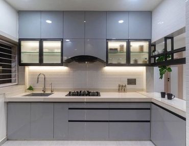 Modern minimalist kitchen with sleek grey cabinets and under-cabinet lighting.