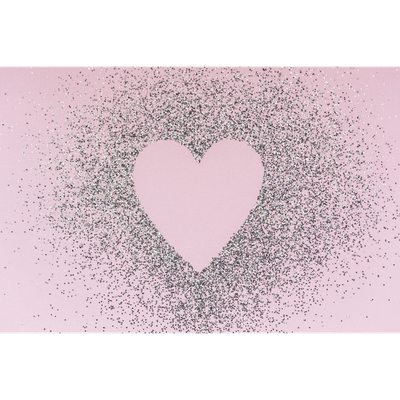Heart shape surrounded by scattered black glitter on a pink background.