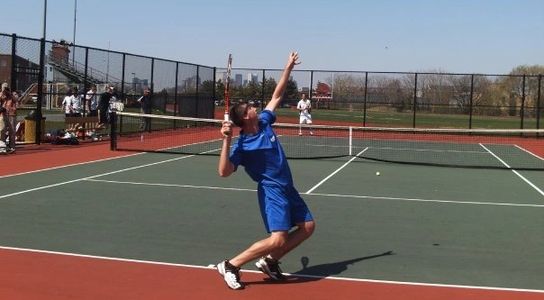 Coach Paul Braude serving in a tennis match