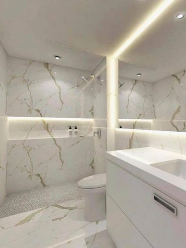 Modern bathroom with marble walls, LED lighting, and sleek white fixtures.