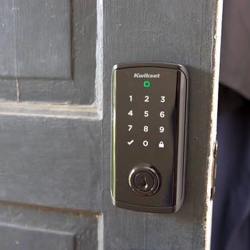 Electronic keypad door lock on a wooden door.