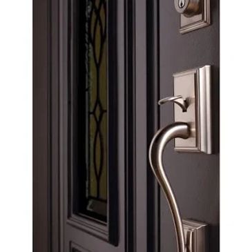 Close-up of an elegant door handle on a dark door.