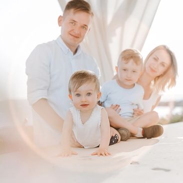 happy family of four smiling to the photographer in cyprus