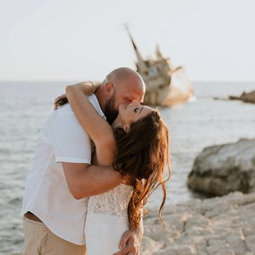 Bride and Groom are cuddling in the background of EdroIII shipwreck in Paphos, Cyprus