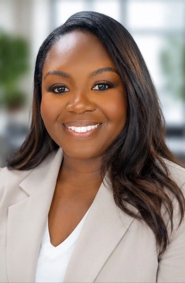 Headshot of a smiling woman with long hair.