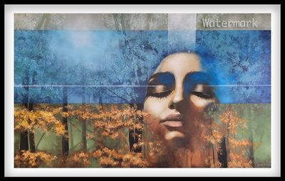 Surreal portrait blending a woman's face with a forest landscape in autumn colors.
