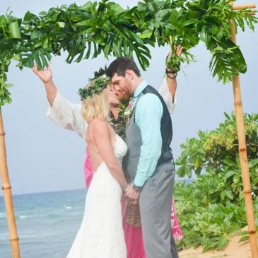 Hawaii wedding ceremony Kahu blessing bamboo arch with monstera green leaves  