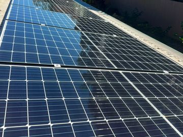 Close-up of solar panels outdoors under sunlight.