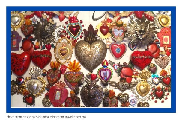 A collection of colorful sacred heart artworks on a wall.