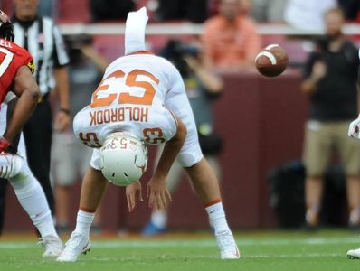 Former University of Texas Longhorn Long Snapper Jak Holbrook snaps against University of Maryland.