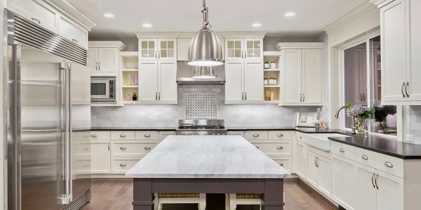 Bright modern kitchen with a large island and stainless steel appliances.