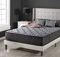 Clean grey mattress in grey painted room