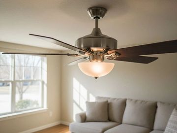 Modern ceiling fan with light in a cozy living room.