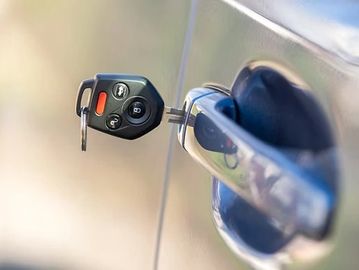 Car key inserted into a car door lock.