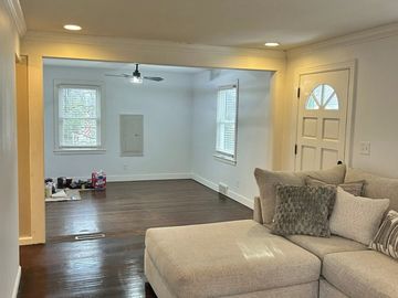 Living room with a sectional sofa and empty adjacent space.
