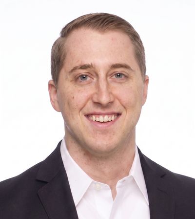 Smiling man in business attire.