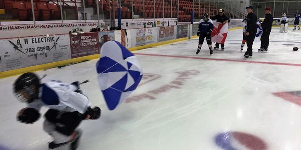 Hockey camp participant doing a parachute drill.