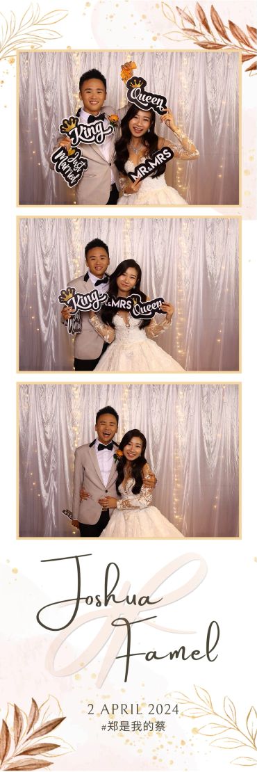 Happy couple celebrating their wedding with playful signs in a photo booth.