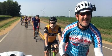 A row of cyclists riding in the country.