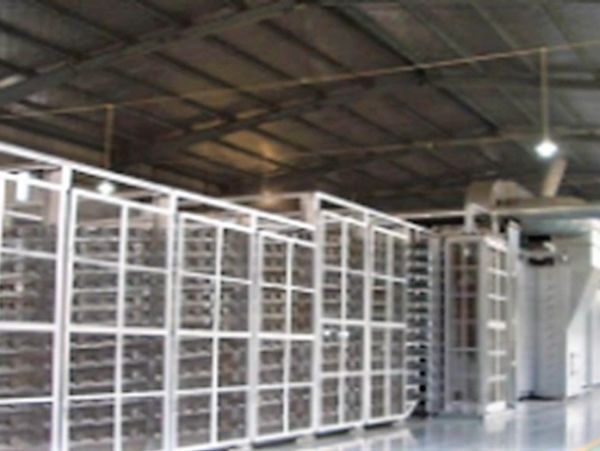Large industrial shelving units inside a warehouse with metal framework.