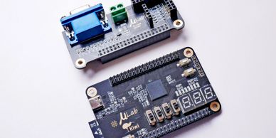 Two electronic development boards on a white surface.