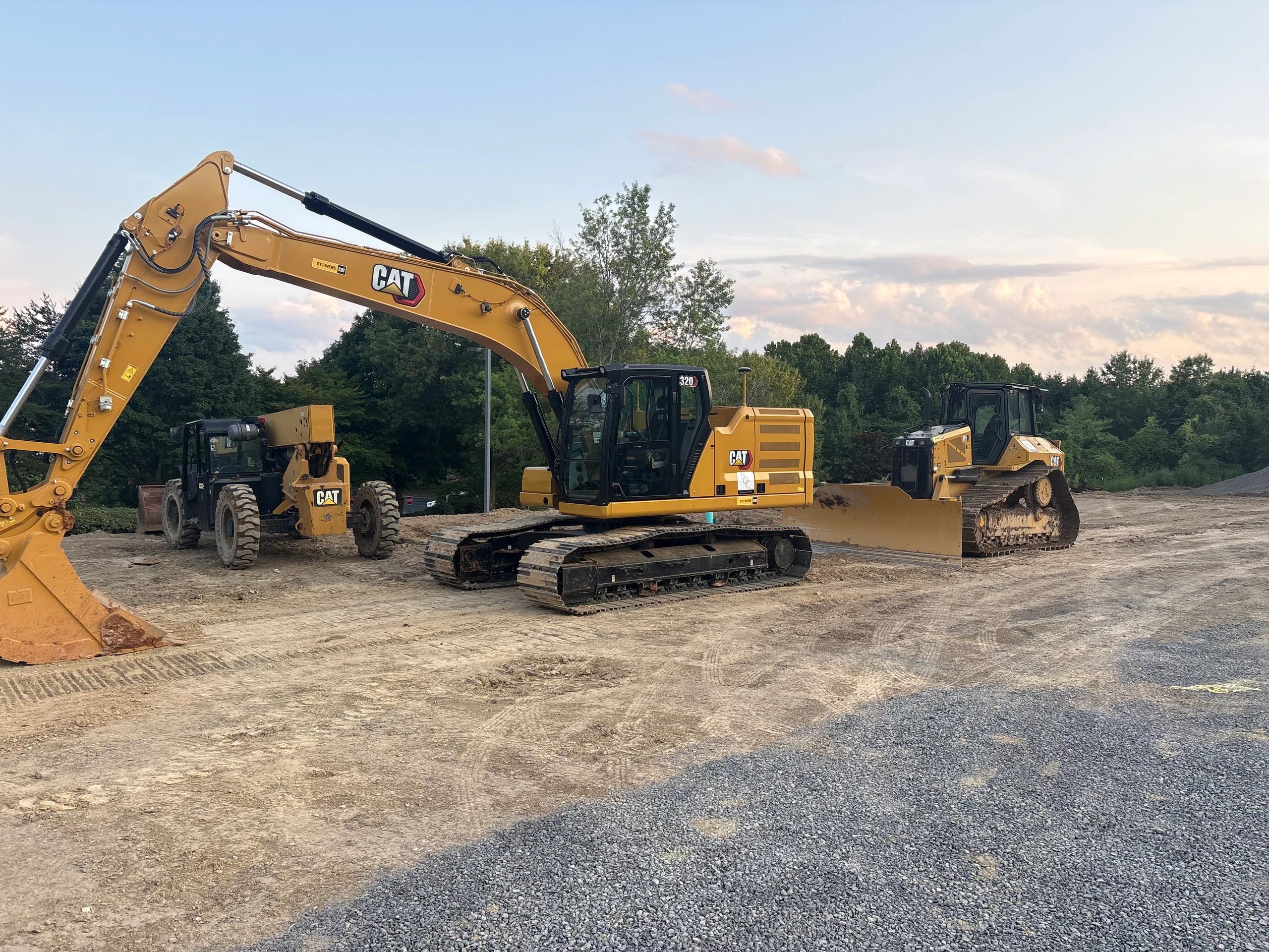 Yellow CAT construction vehicles on a dirt site.