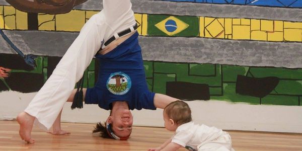 capoeira family playing martial arts fun