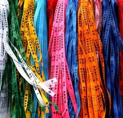 Colorful Brazilian wish ribbons hanging in rows.