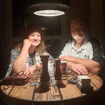 Couple enjoying a cozy dinner under warm lighting.