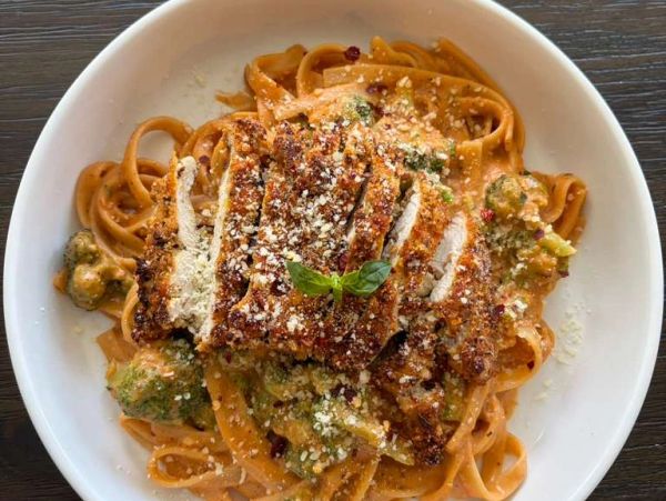 Pasta with creamy sauce and sliced grilled chicken.