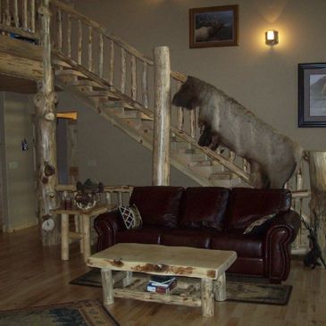 A living area with a wooden coffee table and wooden stairs at the back