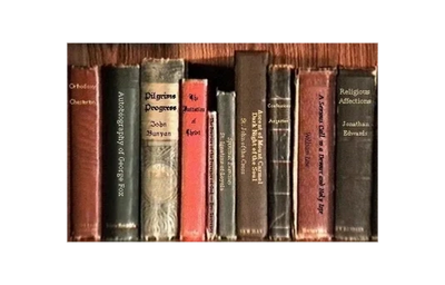 A row of old, classic hardcover books with varied titles and colors.