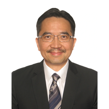 Professional man in suit and tie smiling.