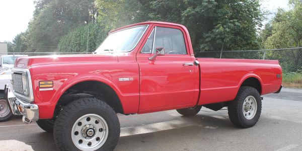 A classic red Chevrolet pickup truck in good condition.