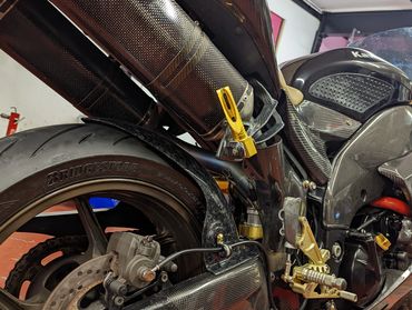 Custom superbike engine upgrade with carbon fibre and gold custom parts.