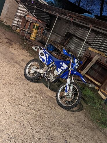 Motorcross motorcycle with custom graphics in Palmers Yard, Newbury.