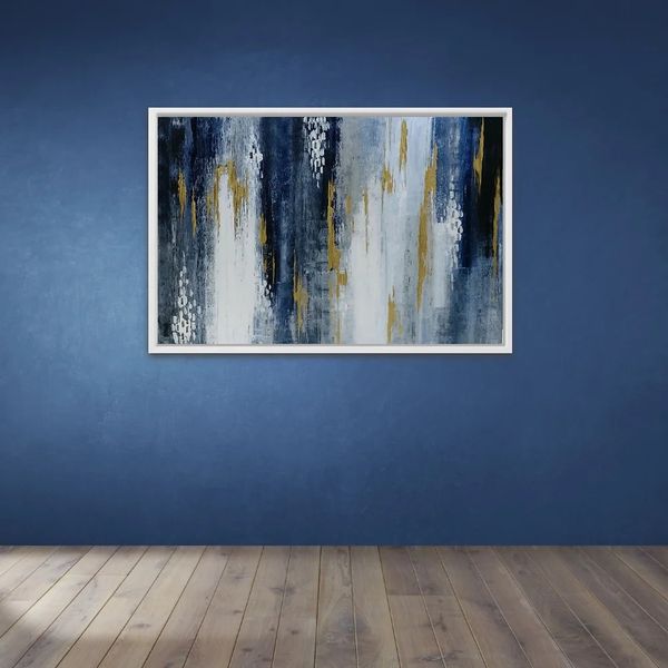 blue white and gold streaks on abstract painting with white frame on a navy blue feature wall.