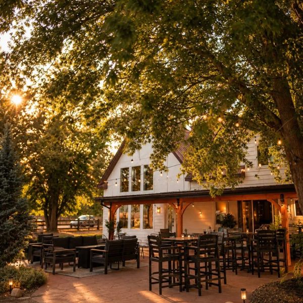 Cozy outdoor seating area at a rustic house during golden hour.