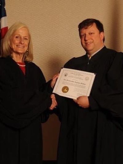 Judge Bishop receives an educational award from Supreme Court Justice Pickering.