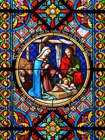 Stained glass nativity scene with Mary, Joseph, and baby Jesus.