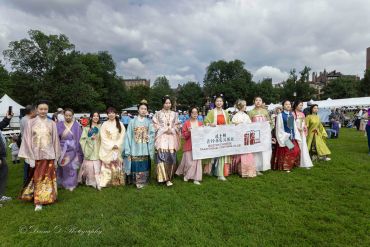 Group of people in traditional attire outdoors.