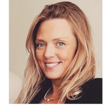 Smiling woman with blonde hair and blue eyes in a black top.